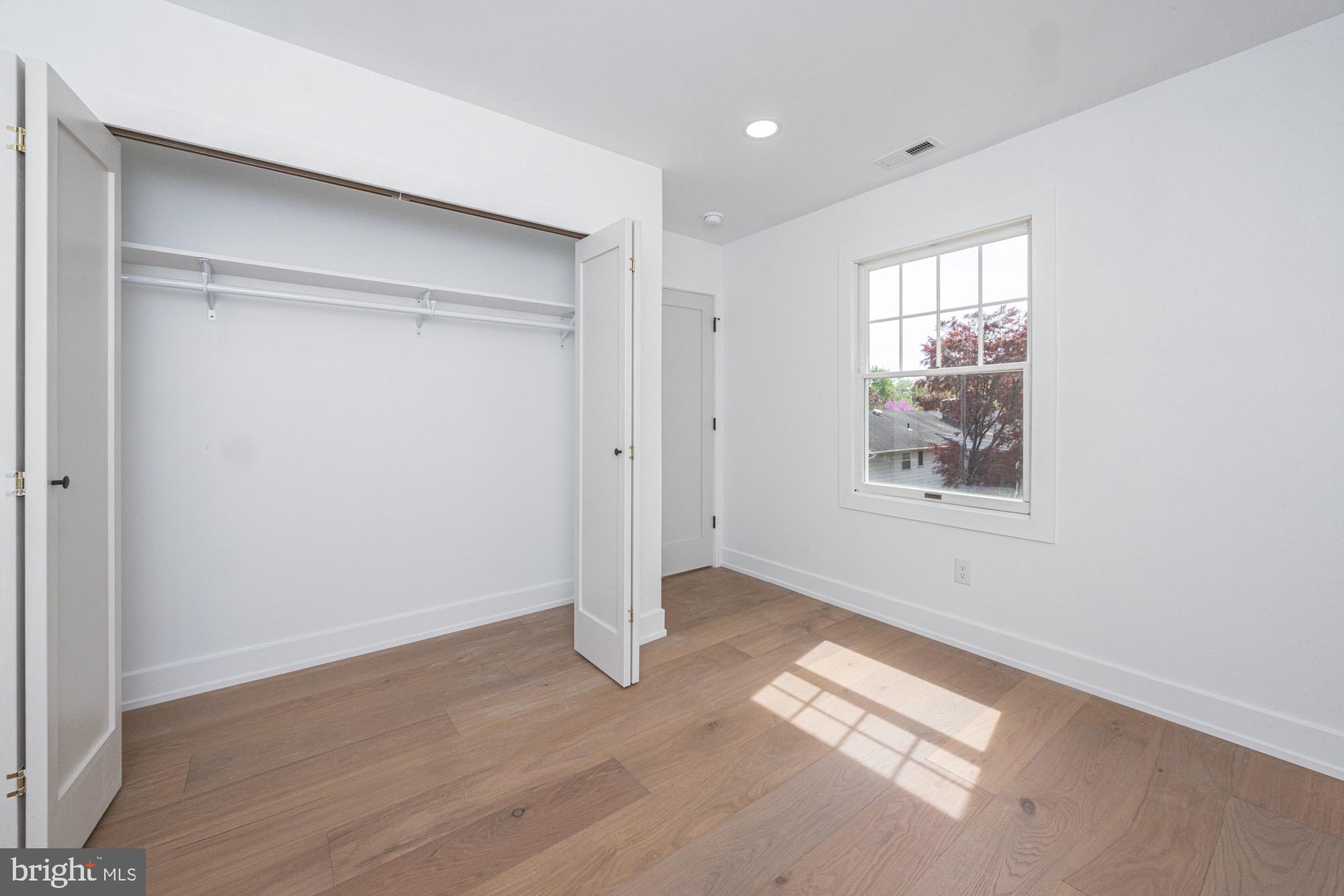 48 Mountainview Court Ewing, NJ 08628 - Photo 29 of 63 a view of an empty room with wooden floor and a window