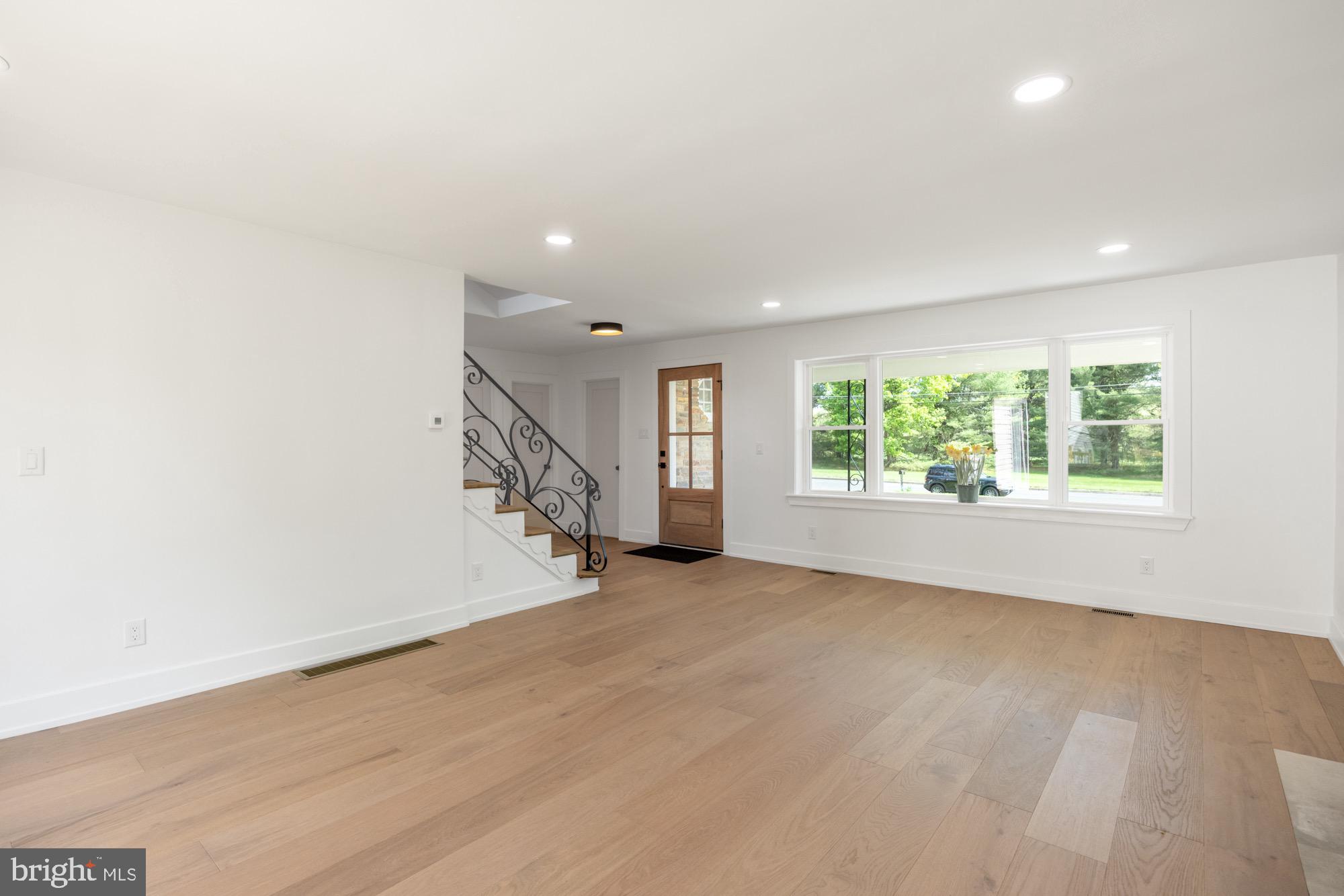 48 Mountainview Court Ewing, NJ 08628 - Photo 7 of 63 an empty room with wooden floor staircase and windows