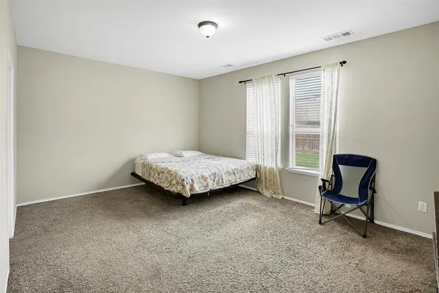 a bedroom with a bed and chair