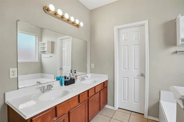 a bathroom with a sink double vanity and a mirror