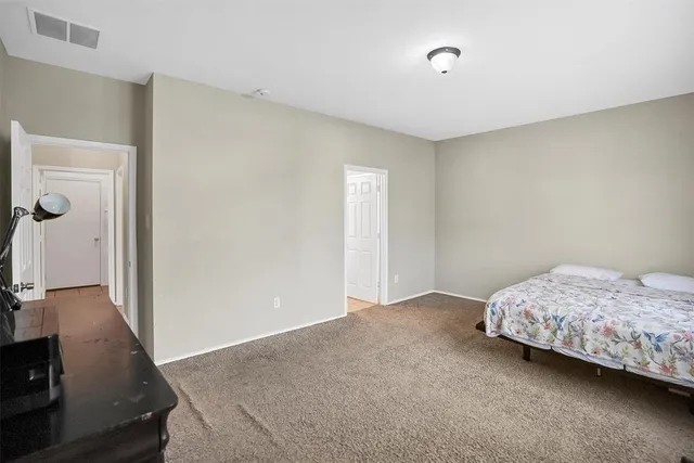an empty room with cabinet and windows