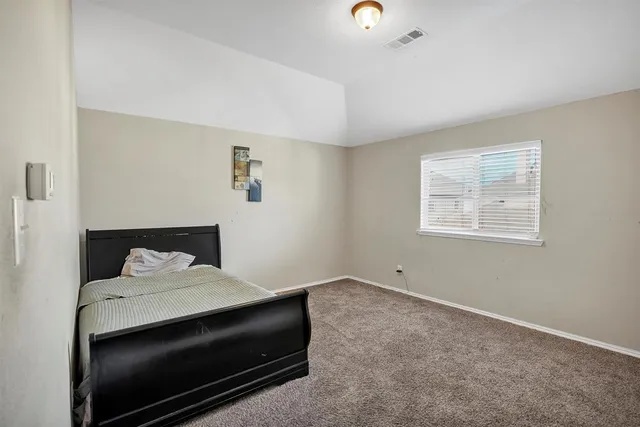 a bedroom with a bed and a cabinets