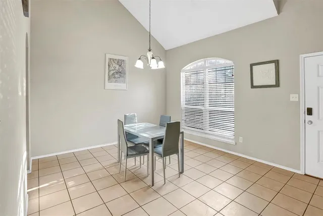 a view of a dining room with furniture and chandelier