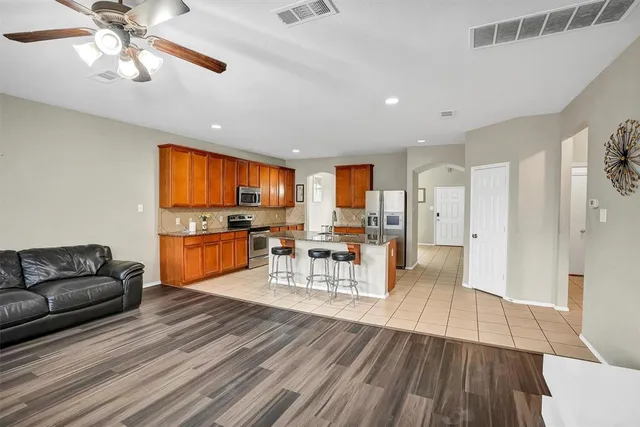 a living room with furniture and kitchen view