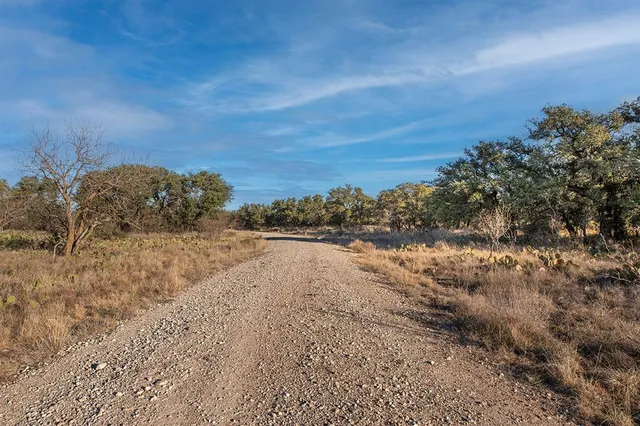 a view of a lake with beach and green space