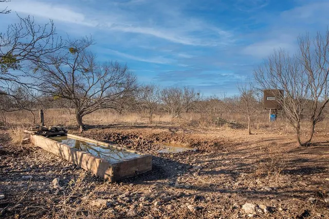 a living room with stainless steel appliances kitchen island granite countertop furniture and a refrigerator