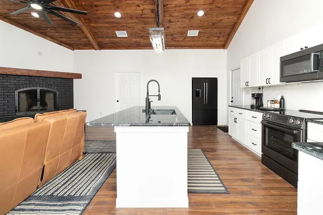 a view of a kitchen with a stove top oven