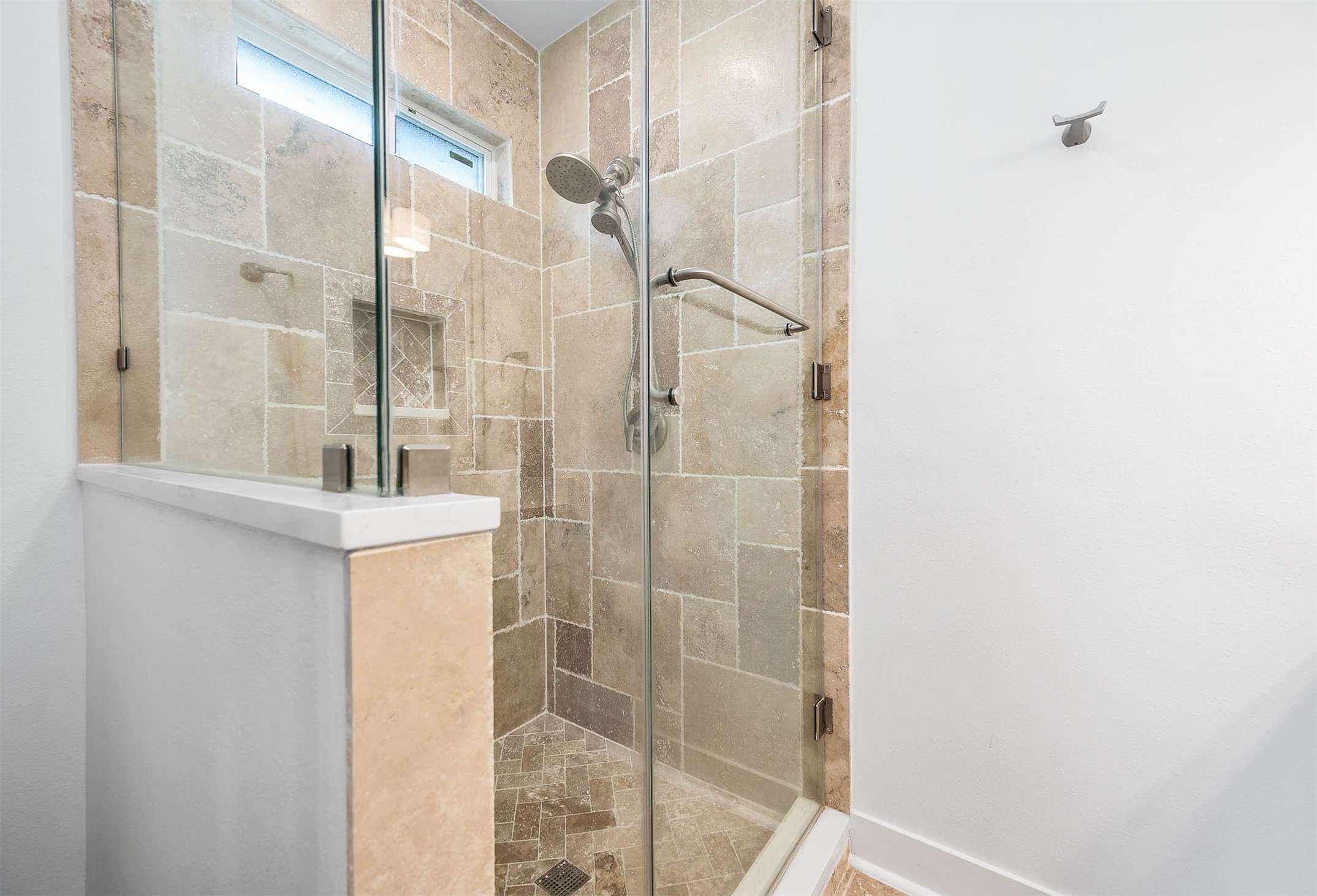 8032 Short Road Needville, TX 77461 - Photo 20 of 50 The primary shower features elegant floor-to-ceiling tile work, a sleek glass enclosure, and a built-in storage niche for added convenience. The modern design and clean finishes create a spa-like feel within the primary bath.