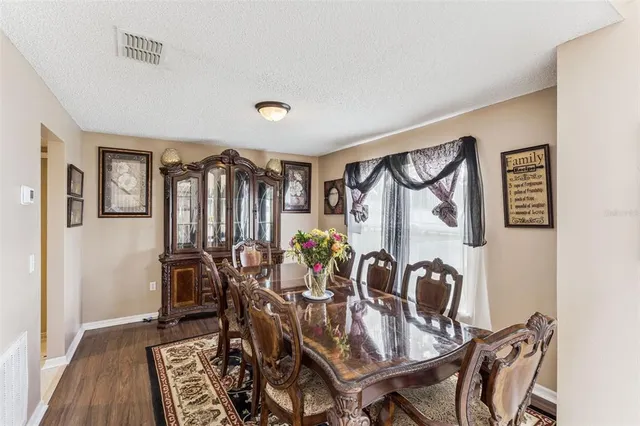 a view of a dining room with furniture and chandelier