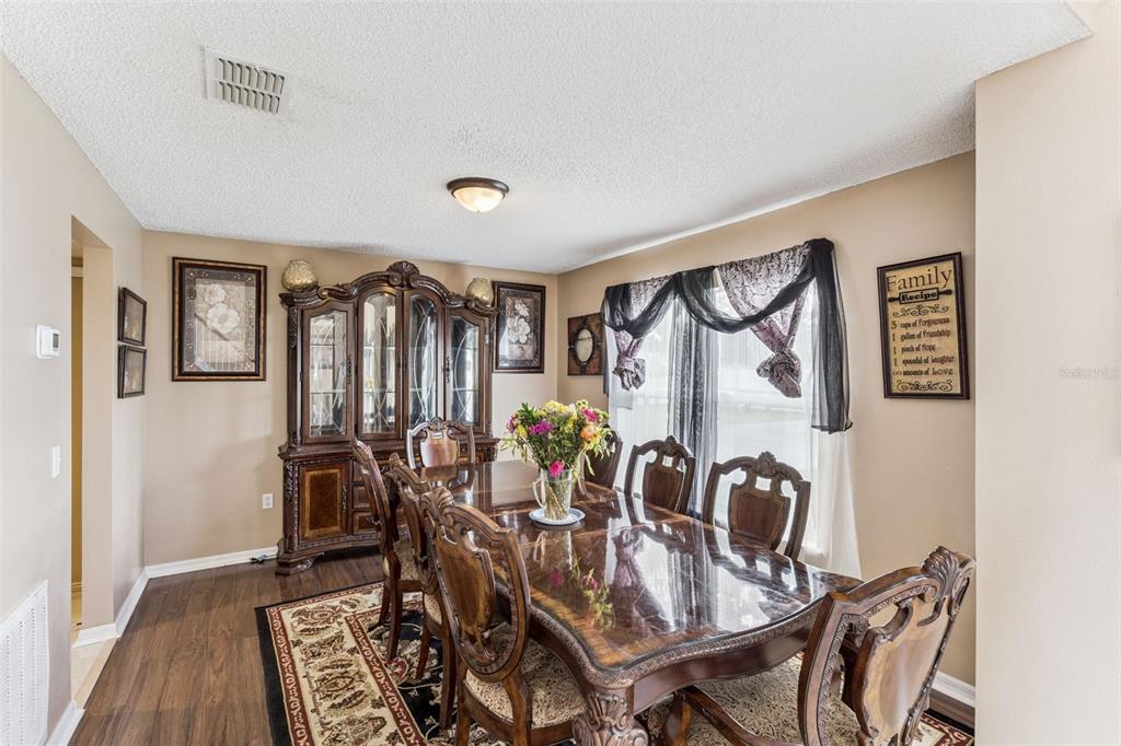 1849 Sunset Ridge Drive Mascotte, FL 34753 - Photo 11 of 29 a view of a dining room with furniture and chandelier