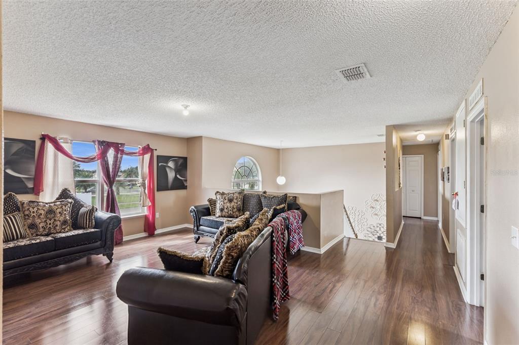 1849 Sunset Ridge Drive Mascotte, FL 34753 - Photo 15 of 29 a living room with furniture and a wooden floor