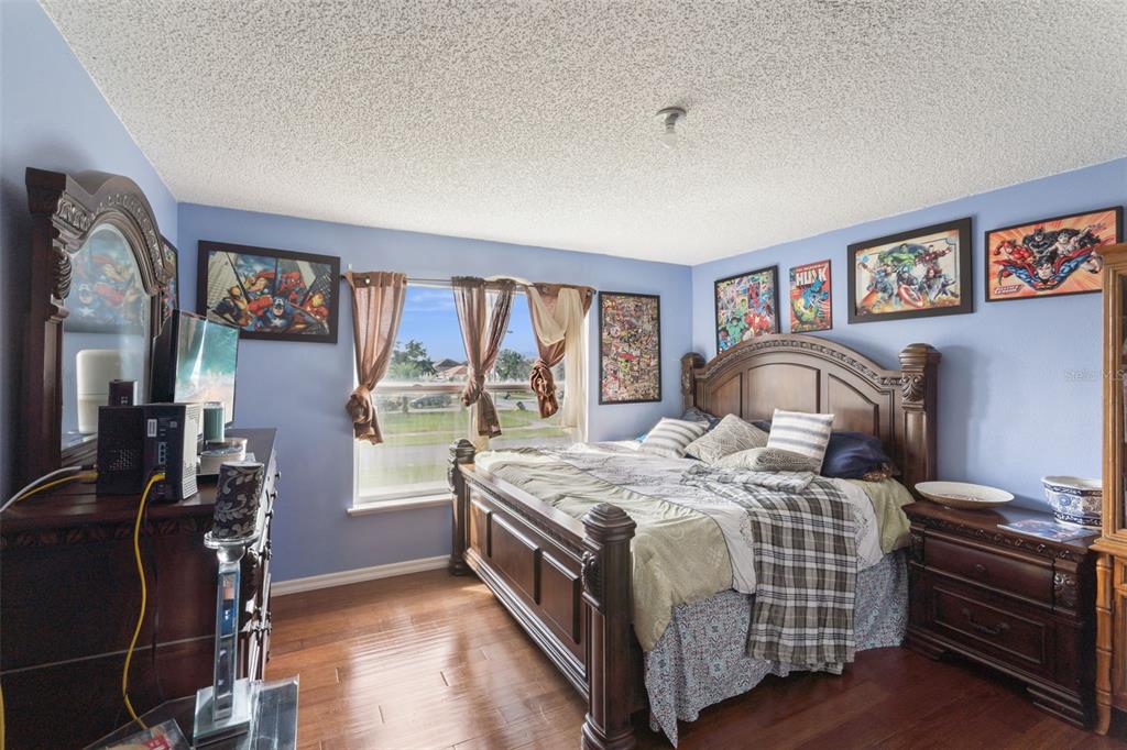 1849 Sunset Ridge Drive Mascotte, FL 34753 - Photo 20 of 29 a bedroom with a bed next to a window