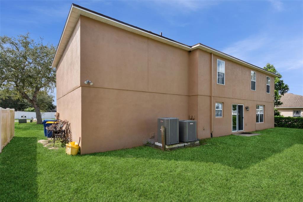 1849 Sunset Ridge Drive Mascotte, FL 34753 - Photo 27 of 29 a view of a backyard with potted plants and a large tree
