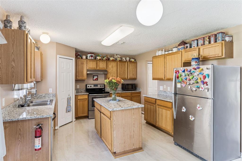 1849 Sunset Ridge Drive Mascotte, FL 34753 - Photo 8 of 29 a kitchen with refrigerator and cabinets