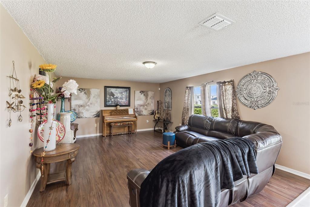 1849 Sunset Ridge Drive Mascotte, FL 34753 - Photo 10 of 29 a living room with furniture and wooden floor