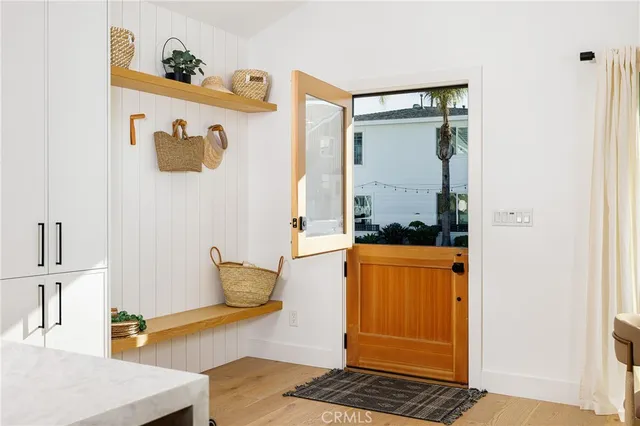a view of kitchen with stainless steel appliances cabinets and a table
