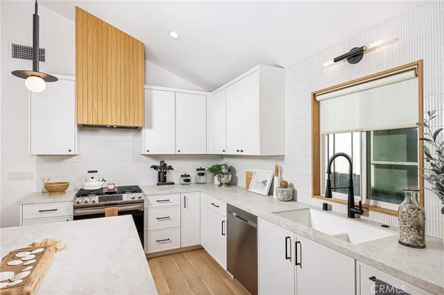 a kitchen with a sink stove and cabinets