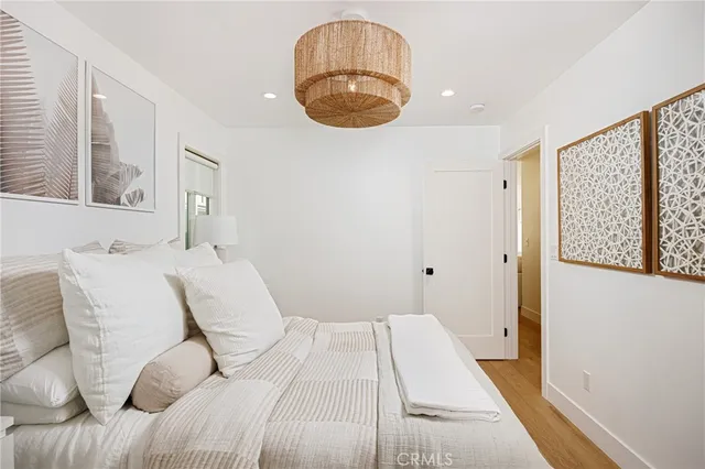 a bedroom with a large bed and a large window