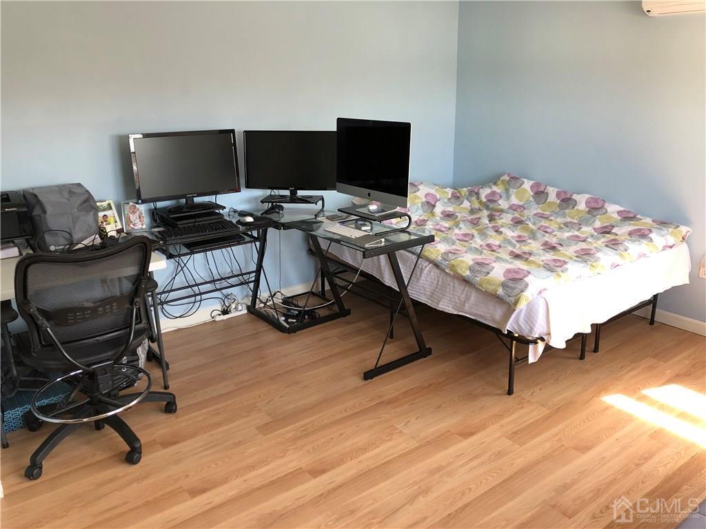 36 Partch Place Edison, NJ 08817 - Photo 11 of 24 a view of a workspace with furniture and a wooden floor