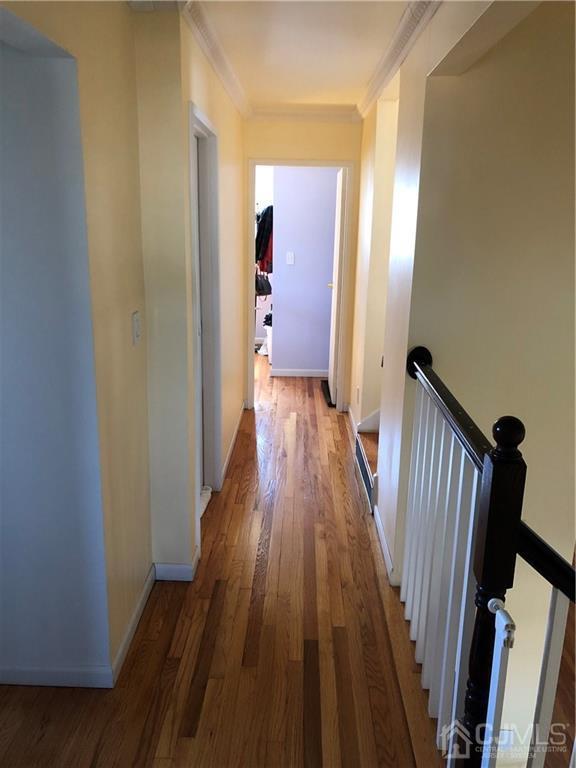 36 Partch Place Edison, NJ 08817 - Photo 13 of 24 a view of a hallway with wooden floor and staircase