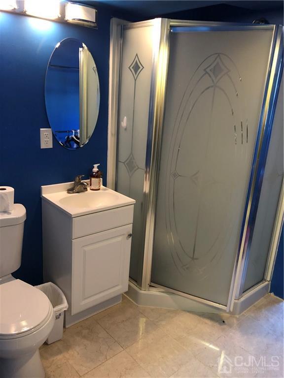 36 Partch Place Edison, NJ 08817 - Photo 14 of 24 a bathroom with a sink a toilet and mirror