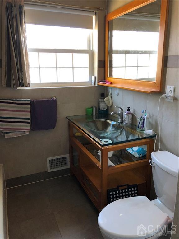 36 Partch Place Edison, NJ 08817 - Photo 15 of 24 a bathroom with a toilet a sink and a window