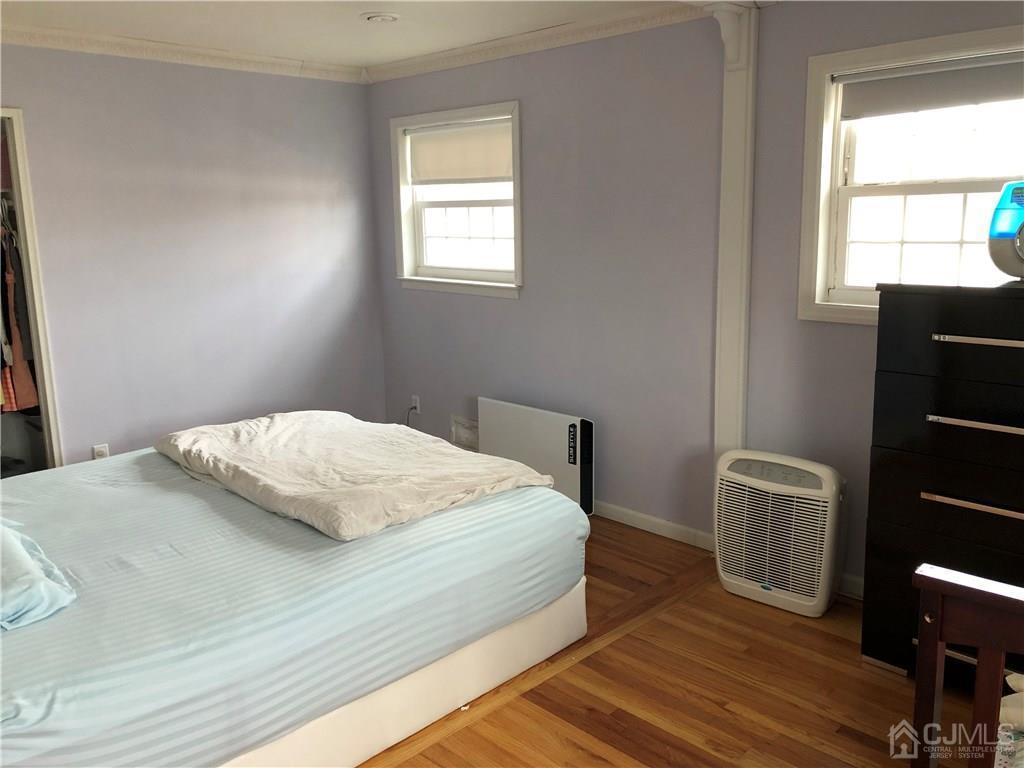 36 Partch Place Edison, NJ 08817 - Photo 17 of 24 a bedroom with a bed and wooden floor