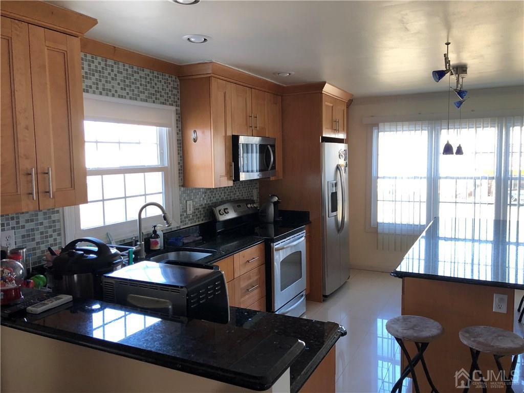 36 Partch Place Edison, NJ 08817 - Photo 2 of 24 a kitchen with a sink stove and refrigerator