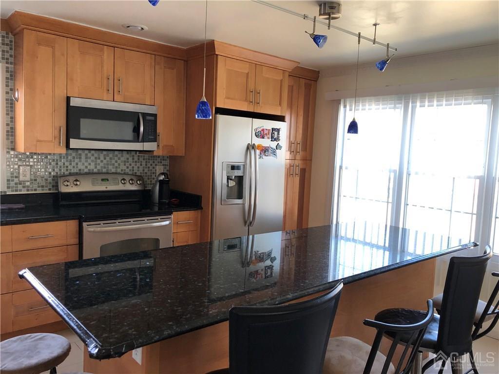 36 Partch Place Edison, NJ 08817 - Photo 24 of 24 a kitchen with stainless steel appliances granite countertop a refrigerator a stove and a sink with wooden floor