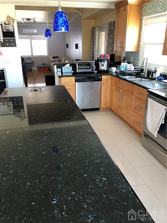 36 Partch Place Edison, NJ 08817 - Photo 3 of 24 a kitchen with stainless steel appliances a sink stove and cabinets