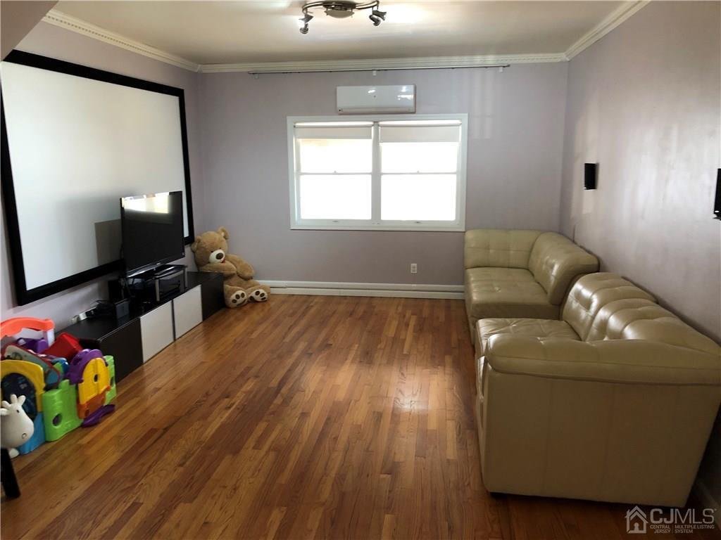 36 Partch Place Edison, NJ 08817 - Photo 5 of 24 a living room with furniture and a flat screen tv