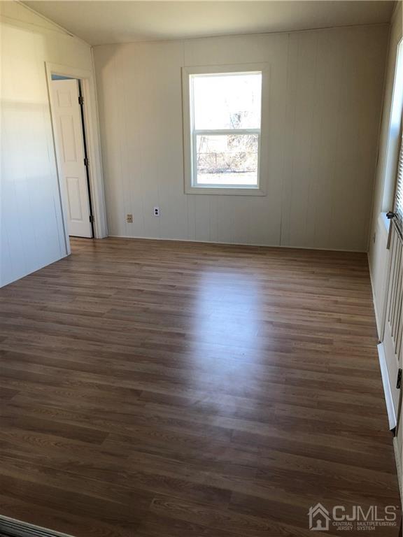 36 Partch Place Edison, NJ 08817 - Photo 6 of 24 an empty room with wooden floor and windows