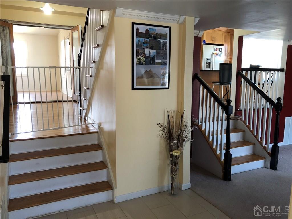 36 Partch Place Edison, NJ 08817 - Photo 7 of 24 a view of staircase with lots of frames on wall and a window