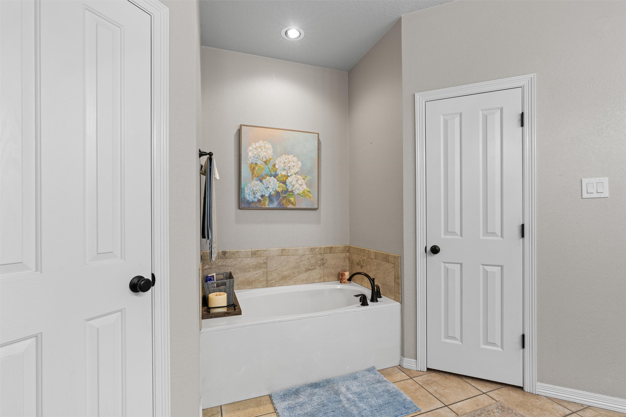 223 East Ridgewood Road Georgetown, TX 78633 - Photo 14 of 40 Relaxation awaits in the primary bathroom featuring a deep soaking tub and 2 separate closets