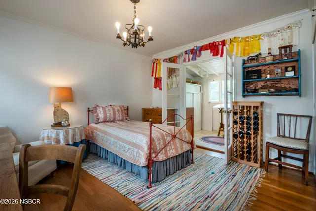 a bedroom with bed and a chandelier