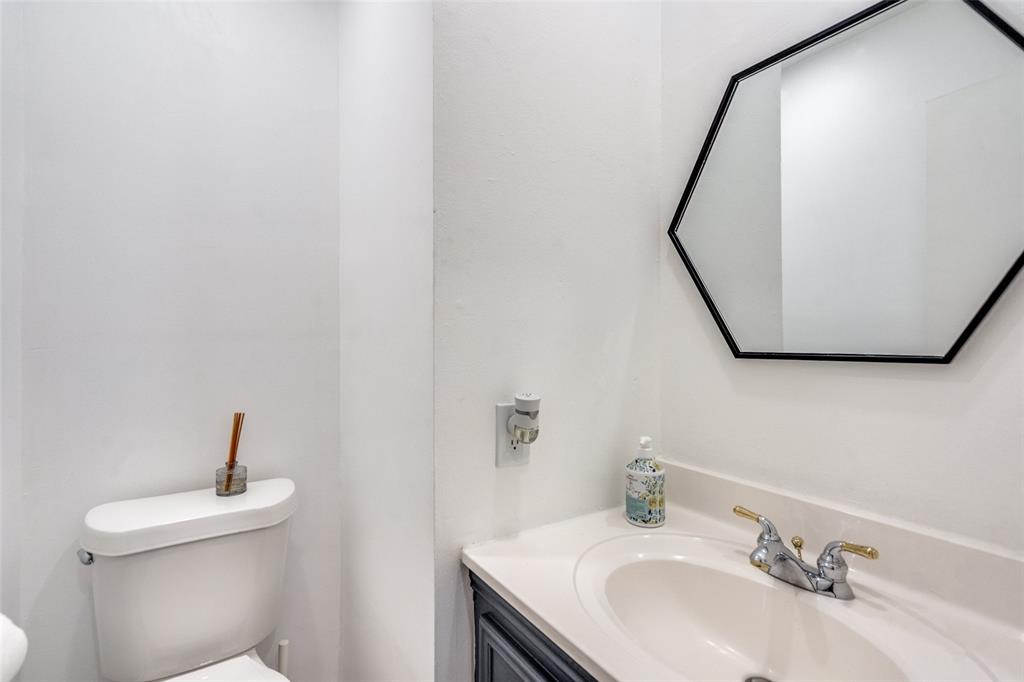 15642 Overmead Circle Dallas, TX 75248 - Photo 15 of 24 a bathroom with a sink and a mirror