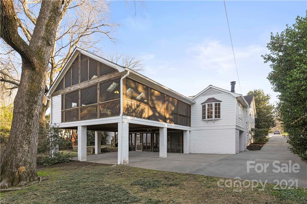 2326 Ferncliff Road Charlotte, NC 28211 - Photo 2 of 48 a view of a white house with large windows and a small yard