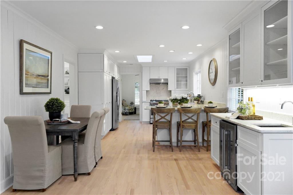 2326 Ferncliff Road Charlotte, NC 28211 - Photo 21 of 48 a very nice looking open dining room with kitchen island furniture a rug and a chandelier