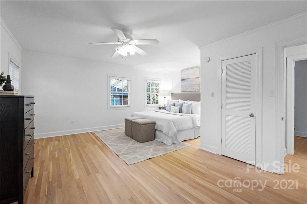 2326 Ferncliff Road Charlotte, NC 28211 - Photo 29 of 48 a bedroom with a large bed and a chandelier