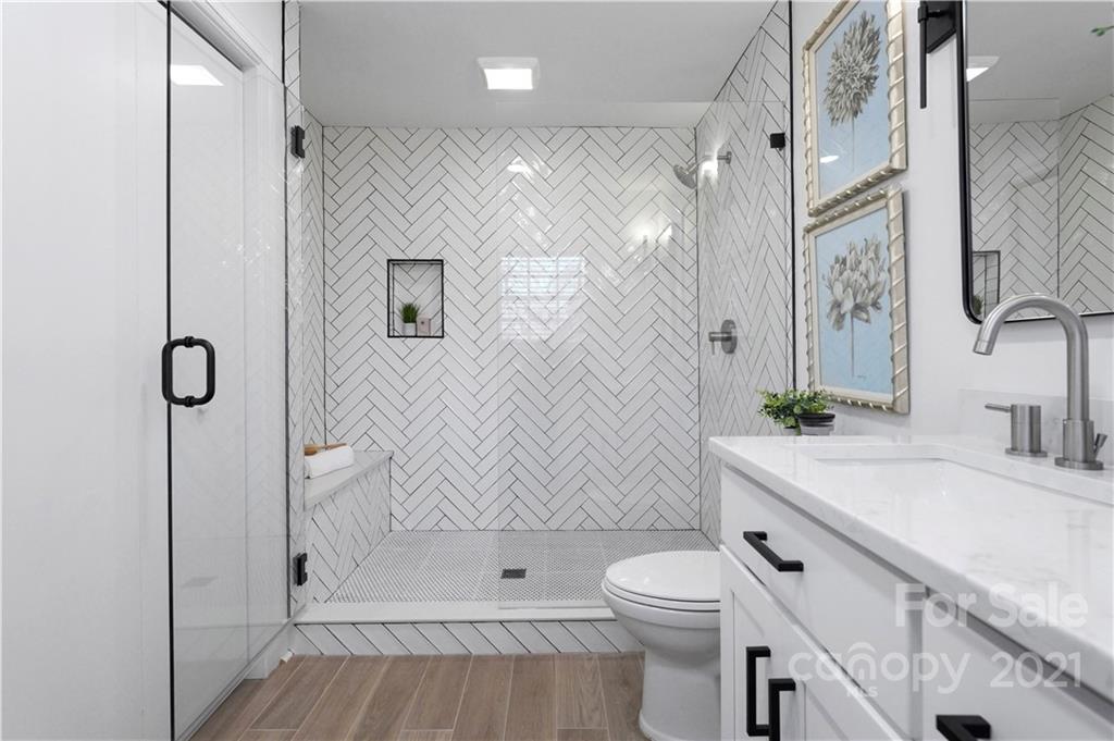 2326 Ferncliff Road Charlotte, NC 28211 - Photo 30 of 48 a bathroom with a sink a toilet and shower