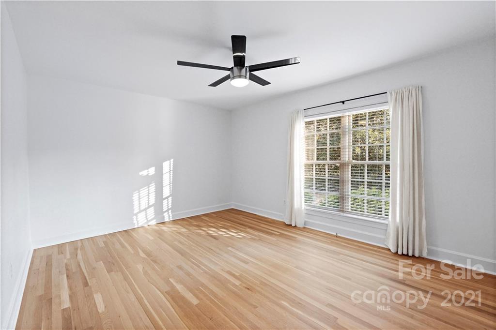2326 Ferncliff Road Charlotte, NC 28211 - Photo 32 of 48 a view of empty room with wooden floor and fan