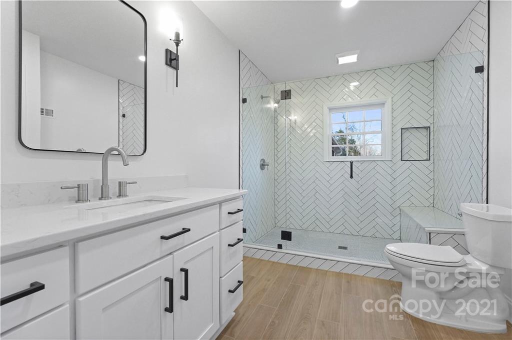 2326 Ferncliff Road Charlotte, NC 28211 - Photo 33 of 48 a bathroom with a tub sink toilet and a mirror