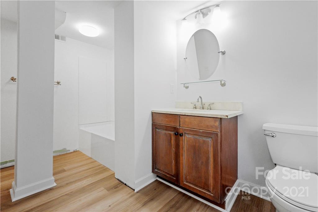 2326 Ferncliff Road Charlotte, NC 28211 - Photo 42 of 48 a bathroom with a toilet sink and mirror