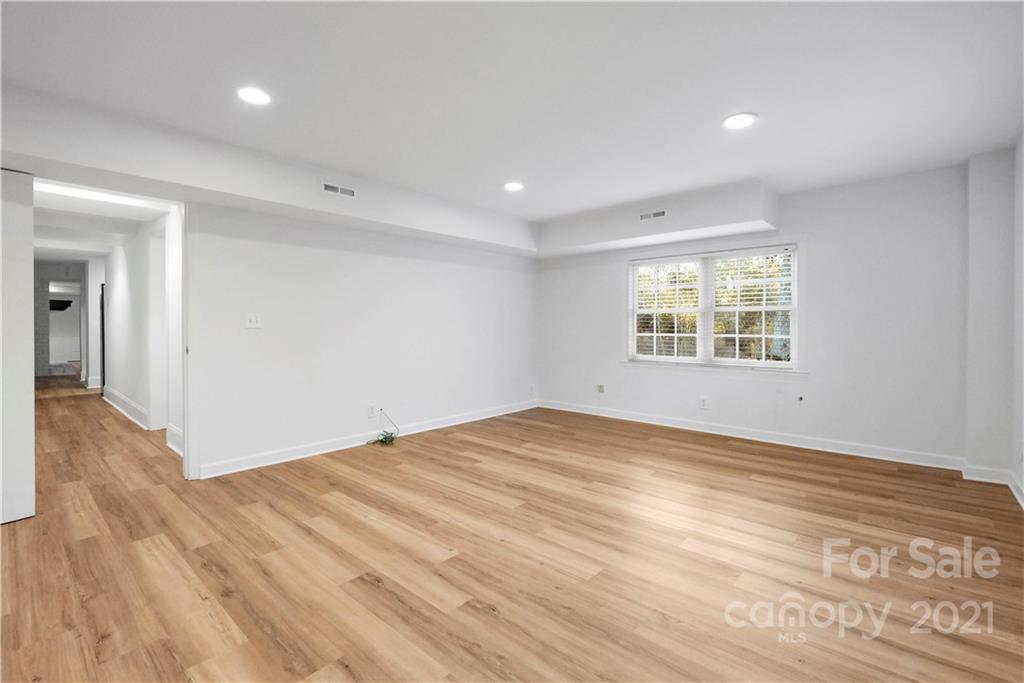 2326 Ferncliff Road Charlotte, NC 28211 - Photo 43 of 48 an empty room with wooden floor and windows