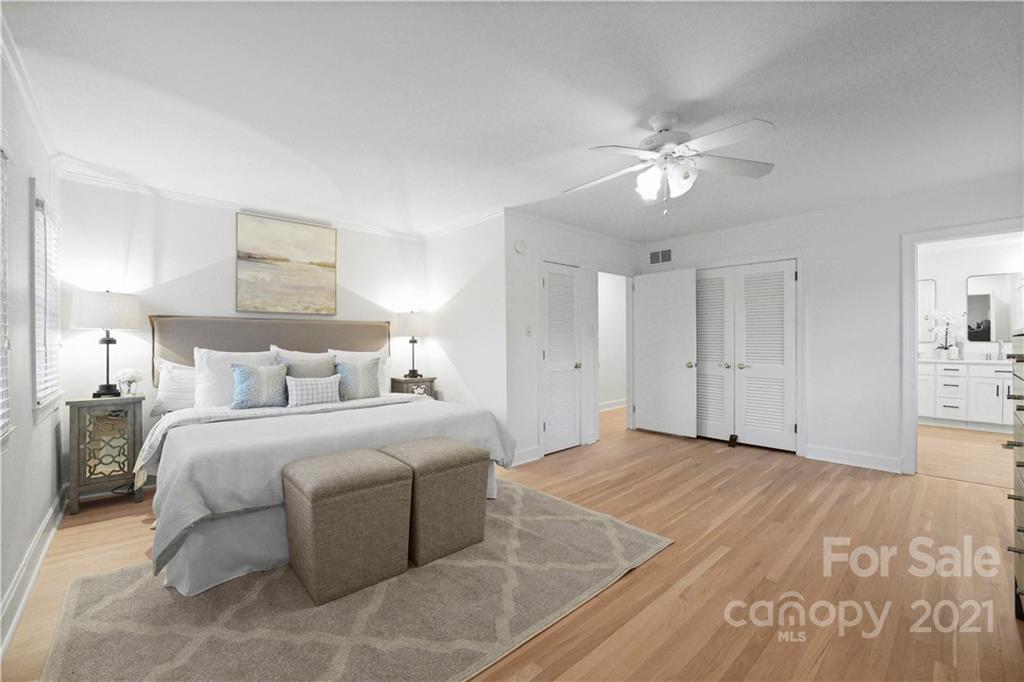 2326 Ferncliff Road Charlotte, NC 28211 - Photo 9 of 48 a spacious bedroom with a bed and a chandelier