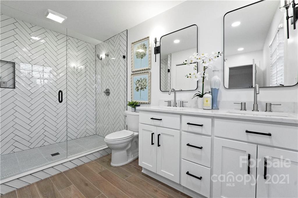 2326 Ferncliff Road Charlotte, NC 28211 - Photo 10 of 48 a bathroom with a double vanity sink mirror double shower and toilet