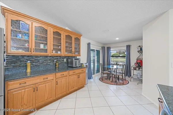 a hall with a sink and cabinets