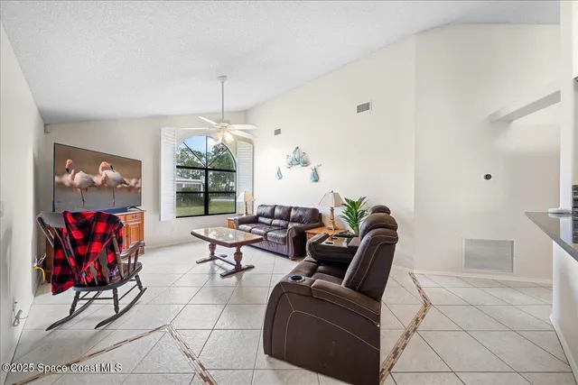 a living room with furniture a rug and a window