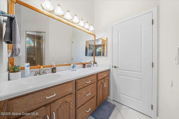 a bathroom with a double vanity sink and a mirror