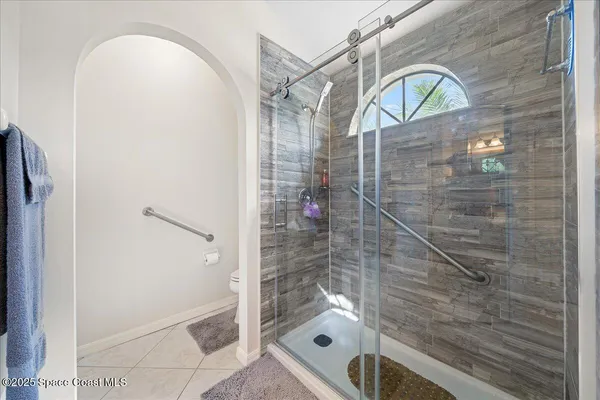a bathroom with a shower and a sink